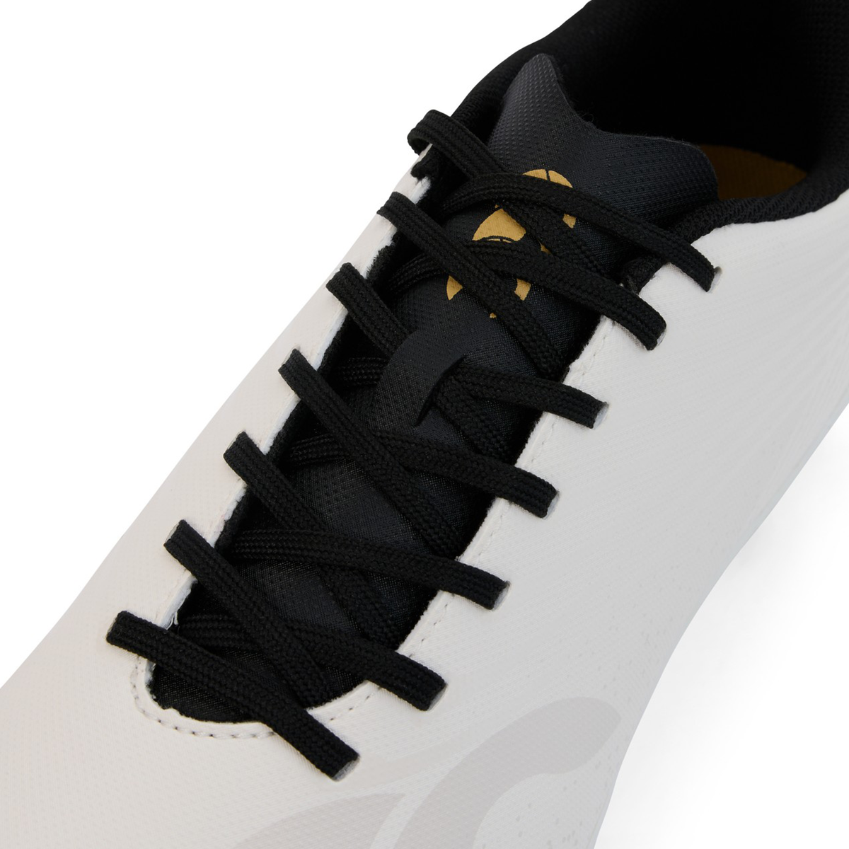Close-up of the upper section of the Canterbury Stampede Groundbreak Team SG - White rugby boots by Canterbury, featuring black laces threaded through six eyelets and a black tongue.