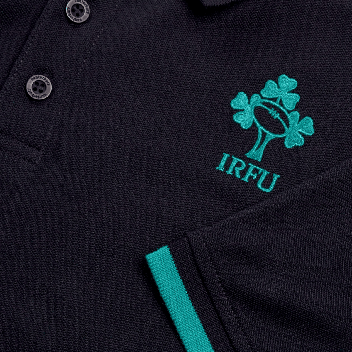 Close-up of the Ireland 25/26 Team Polo by Canterbury, featuring the IRFU logo with a shamrock and rugby ball, detailed embroidery, and green sleeve trim.