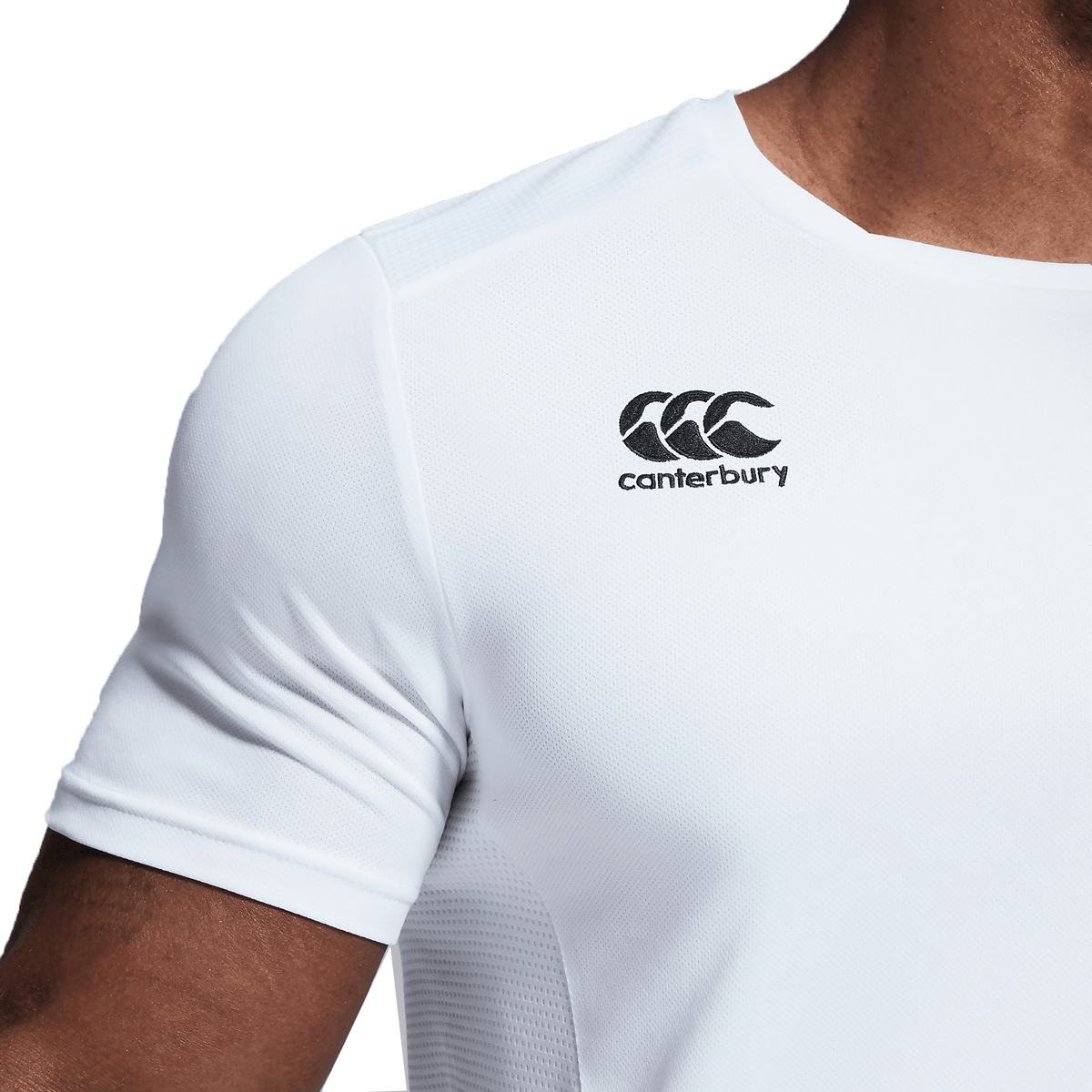 A close up of a man wearing a white Canterbury Club Dry Tee from Canterbury.