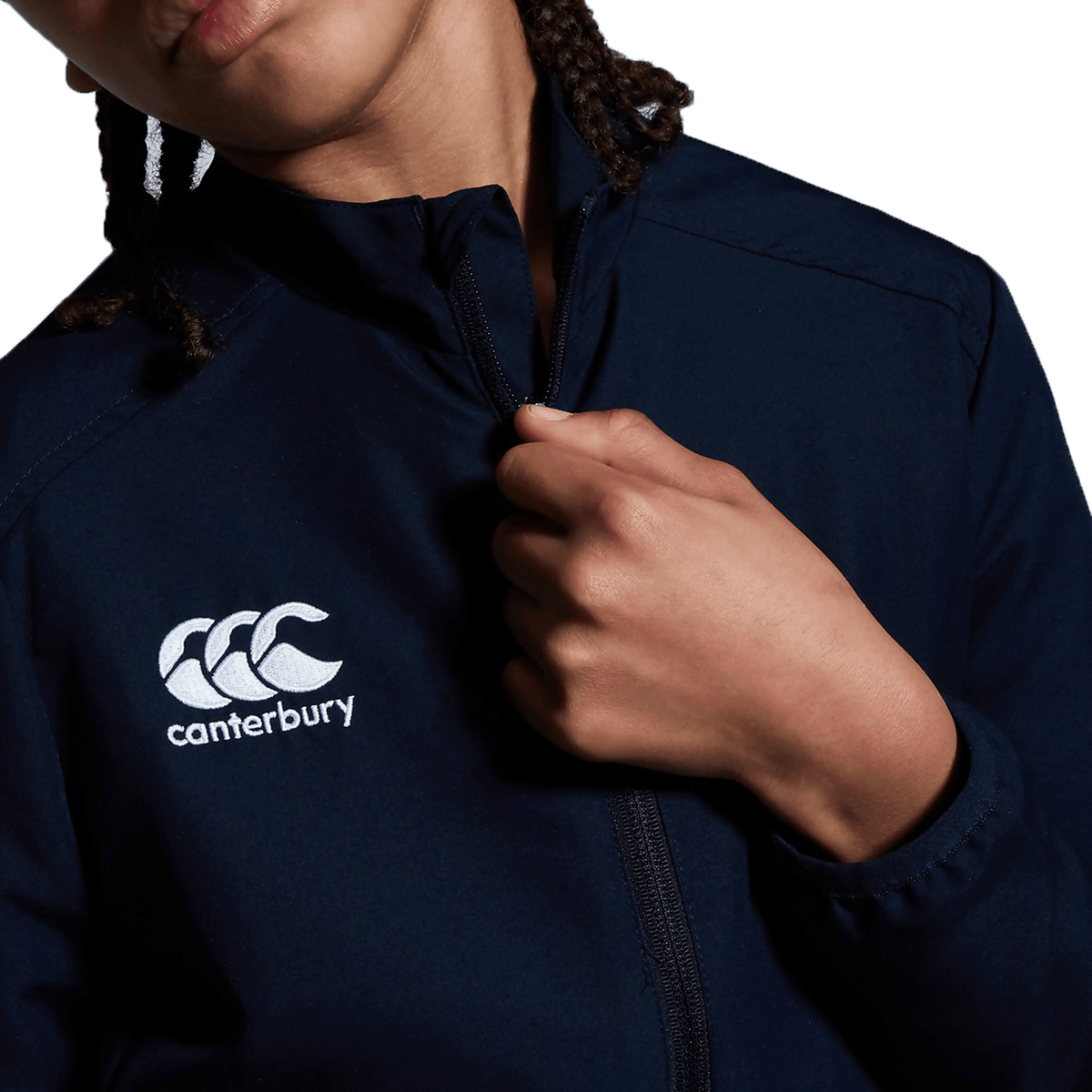 A woman wearing a Canterbury Club Track Jacket and braids.