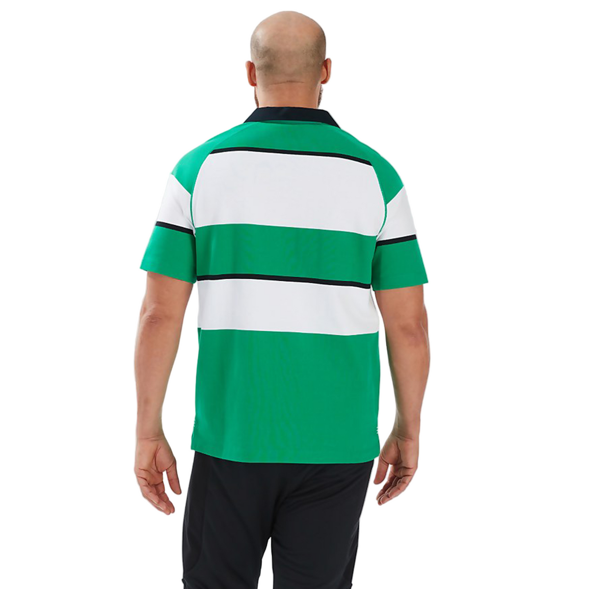 A person with a shaved head is seen from behind, wearing the Canterbury Ireland 25/26 Heritage Hooped Jersey with green, white, and black stripes against a plain background.