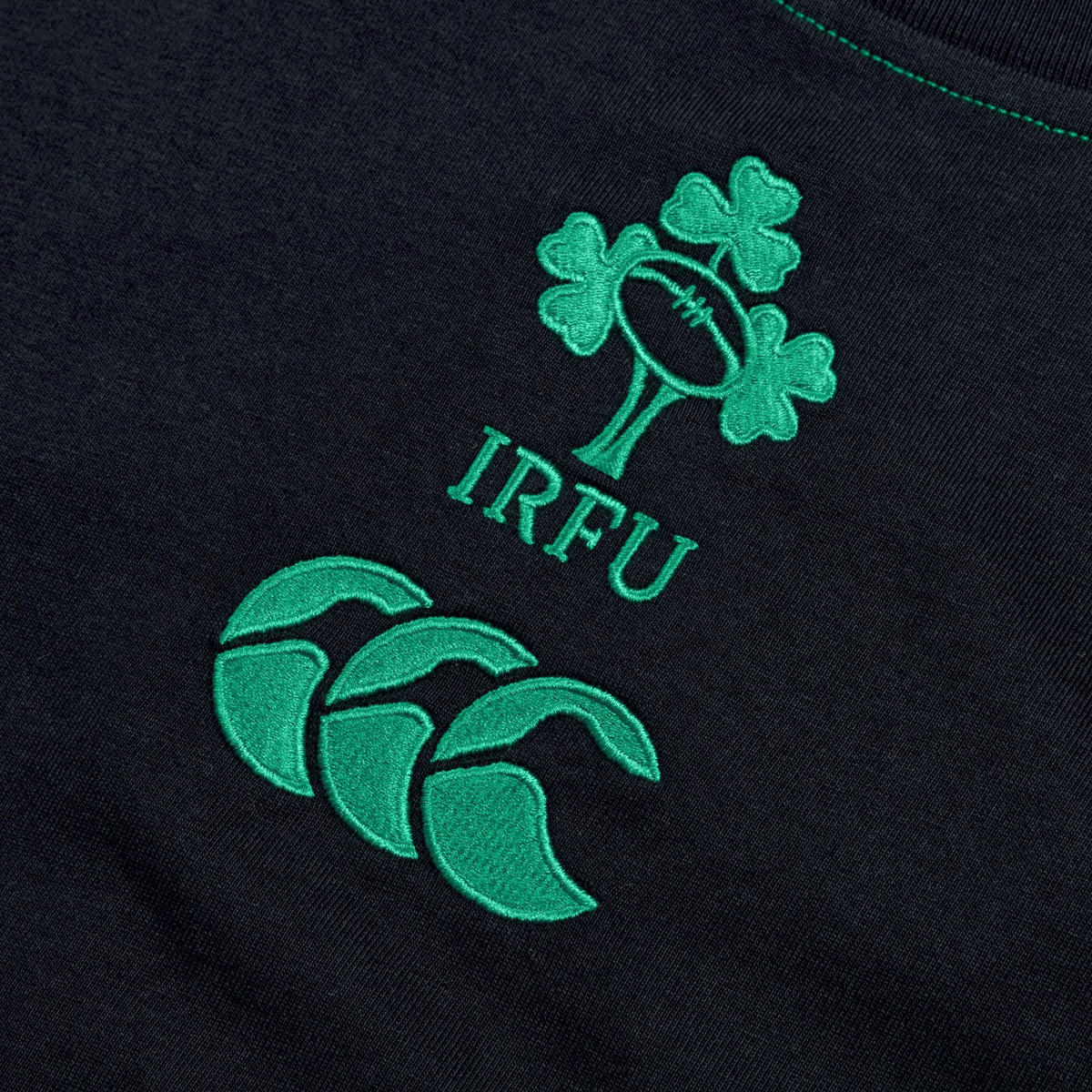 The image shows the Ireland Rugby Football Union (IRFU) logo and the Canterbury logo embroidered on a dark Ireland Team Cotton T-Shirt 24 by Canterbury.