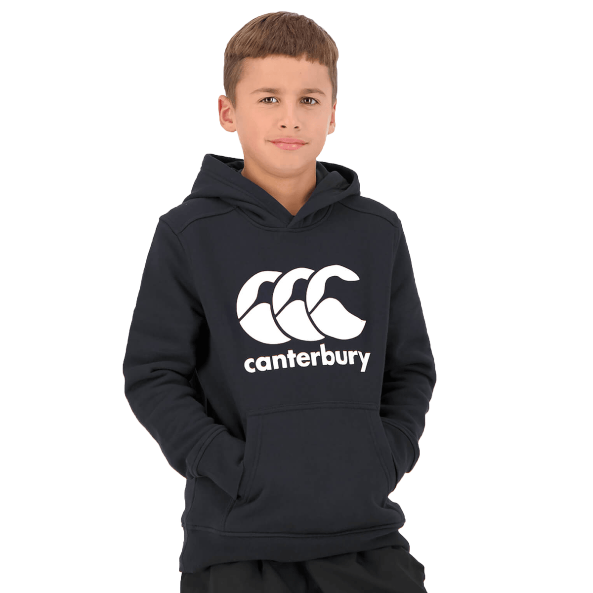 A young boy wearing a Canterbury Anchor Hoodie stands with one hand in his pocket against a white background.