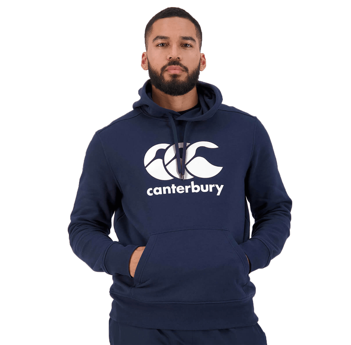 A person in a Canterbury Anchor Hoodie by Canterbury, featuring a navy blue color, front pocket, drawstring hood, and fleece lining for added warmth, stands against a plain white background.
