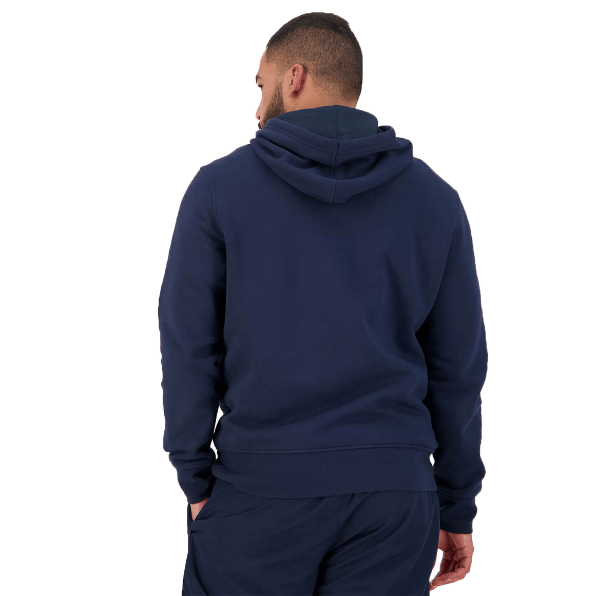 A person stands facing away, wearing the Canterbury Anchor Hoodie paired with matching navy pants.