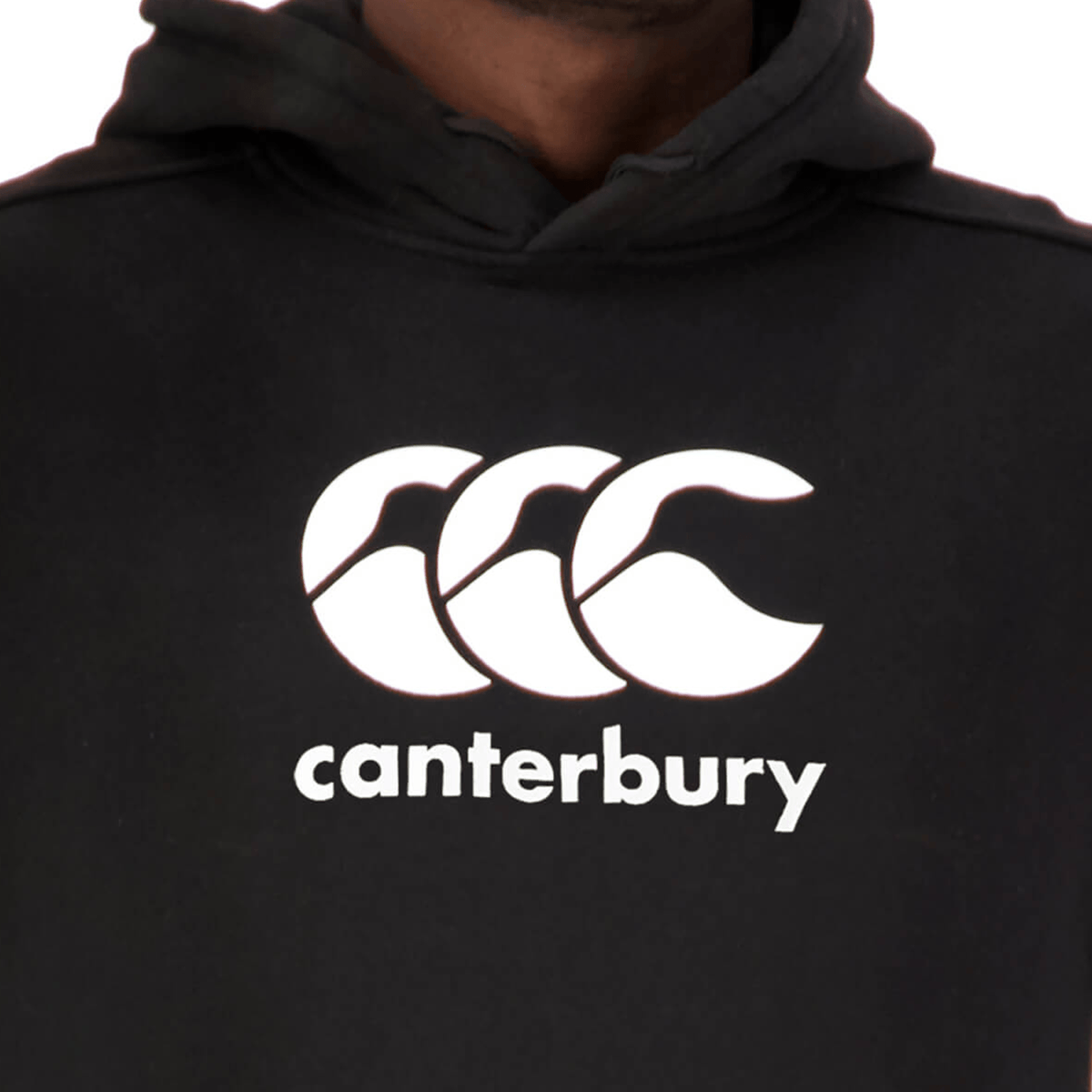 A person wearing a black Canterbury Anchor Hoodie, fleece-lined and featuring the Canterbury logo on the chest.