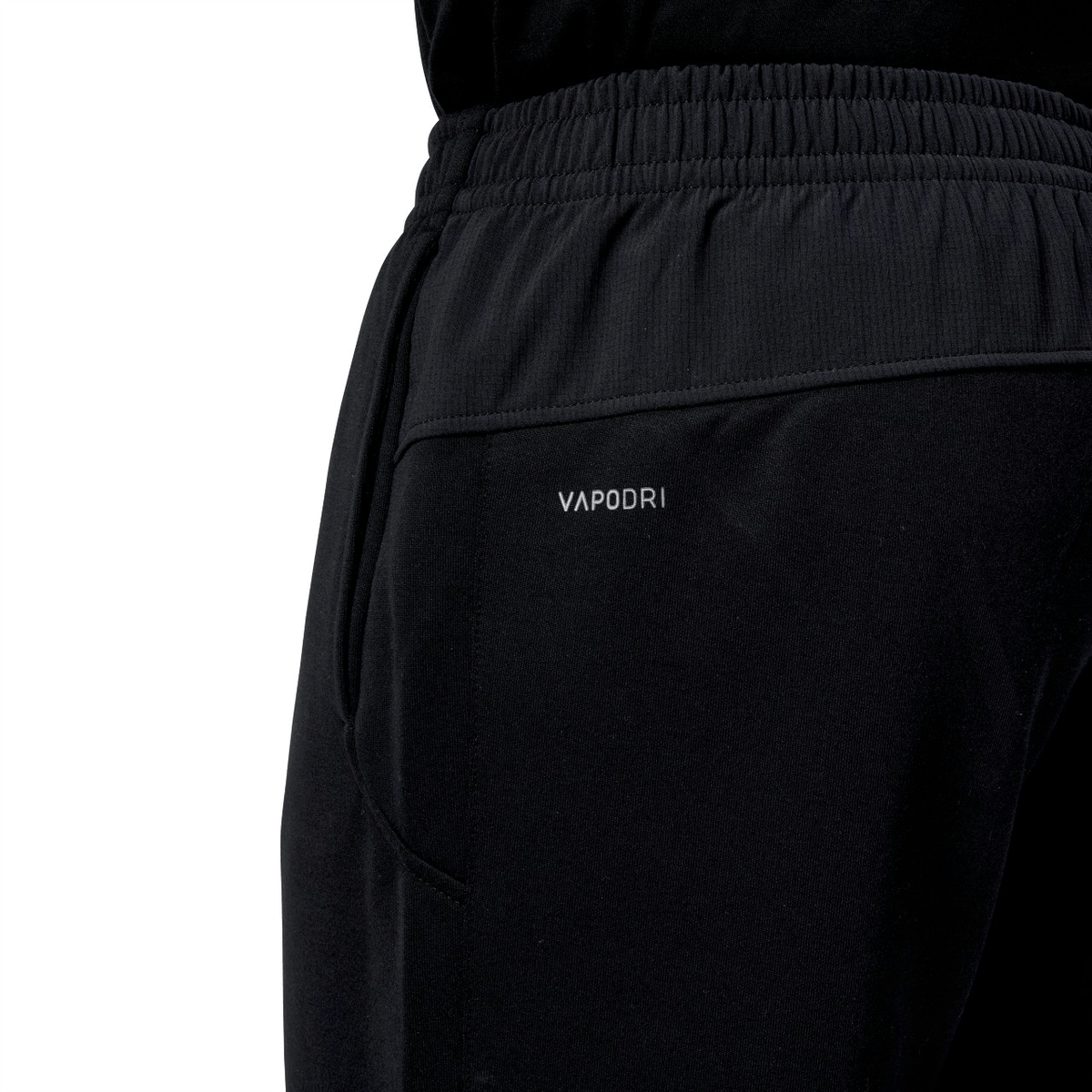 Close-up of the Canterbury Tempo Vapodri Hybrid Cuffed Pant, highlighting its black athletic design. Attention is on the elasticated waistband and side seam, providing comfort and style.