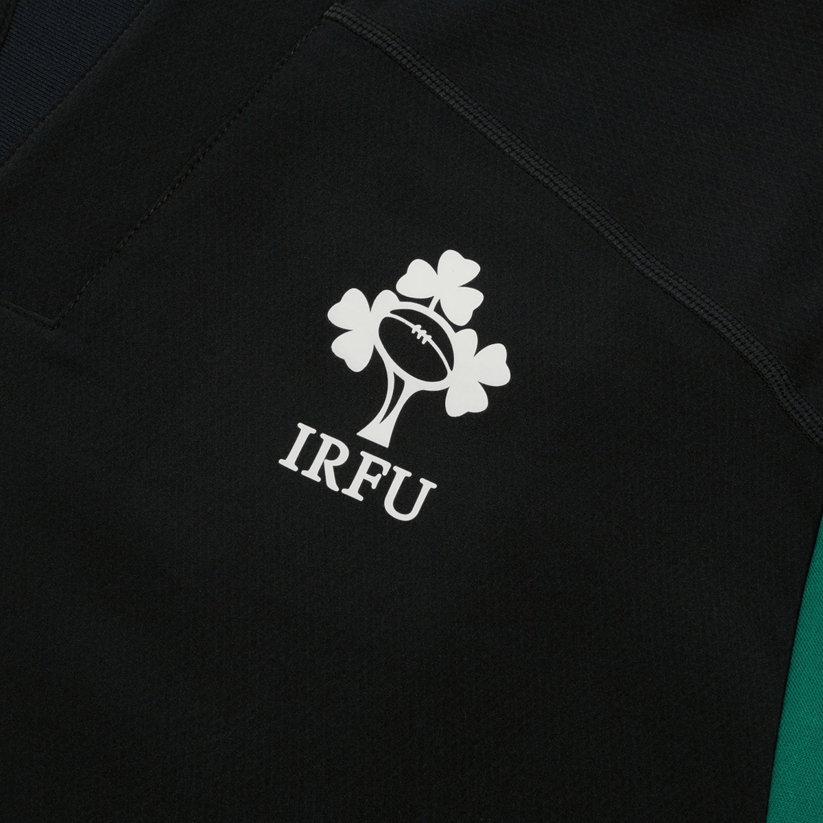 Close-up of the Ireland 25/26 Tech Drill Top by Canterbury, featuring the IRFU logo with rugby ball and shamrocks—ideal as a weatherproof training top.