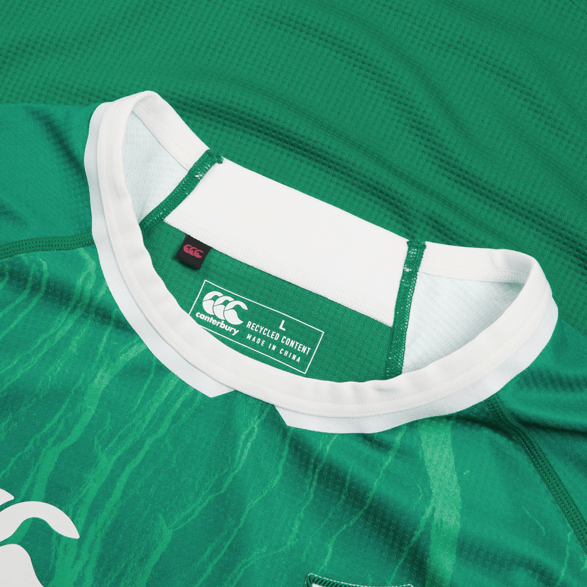 Close-up of an Ireland 24 Home Pro Jersey by Canterbury, featuring a green design with a white collar and the Canterbury label. The jersey is size large and crafted from recycled content in China.
