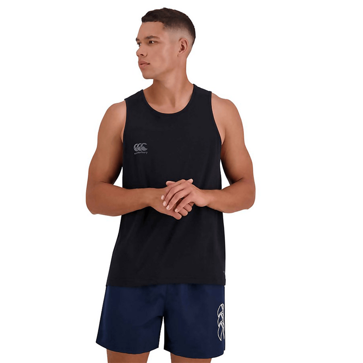 A man wearing a black Canterbury Tempo Vapodri Singlet, which is made of recycled polyester and features VapoDri technology to keep him dry and comfortable.