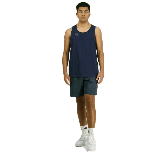 A man is standing, facing forward, wearing a navy Canterbury Tempo Vapodri Singlet made with quick-drying VapoDri technology, dark blue shorts, white socks, and white shoes against a white background.