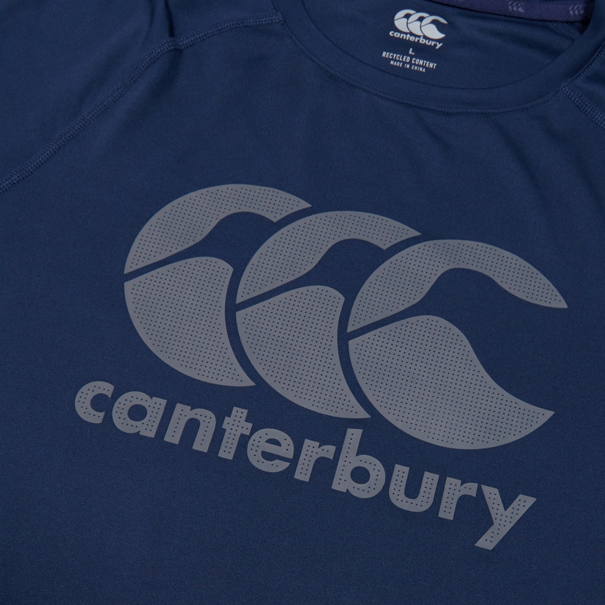 Close-up of the Canterbury Large Logo Superlight Tee, a lightweight performance shirt in blue with Canterbury’s name and logo in large gray print—ideal for rugby training.
