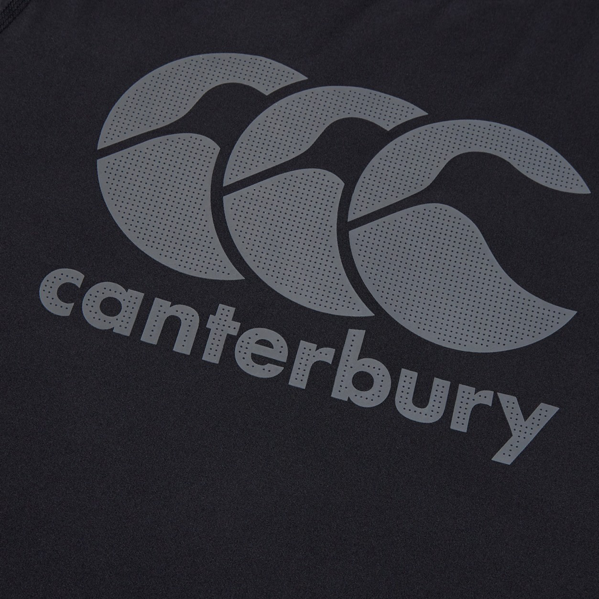 Close-up of the Canterbury Large Logo Superlight Tee, displaying the iconic Canterbury logo with three overlapping grey motifs above "canterbury" in lowercase—a lightweight, high-performance shirt ideal for rugby training.