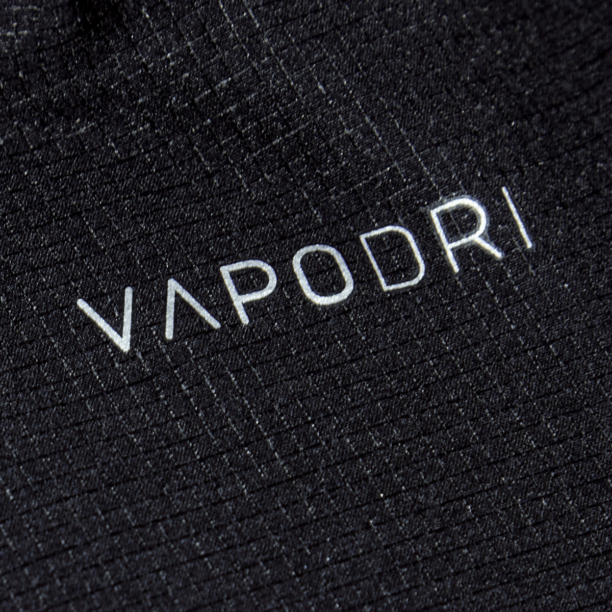 Close-up of black Vapodri fabric with &quot;VAPODRI&quot; printed in white, known for its sleek design and durability, as seen in Canterbury&#39;s Women&#39;s Yokohama Short.