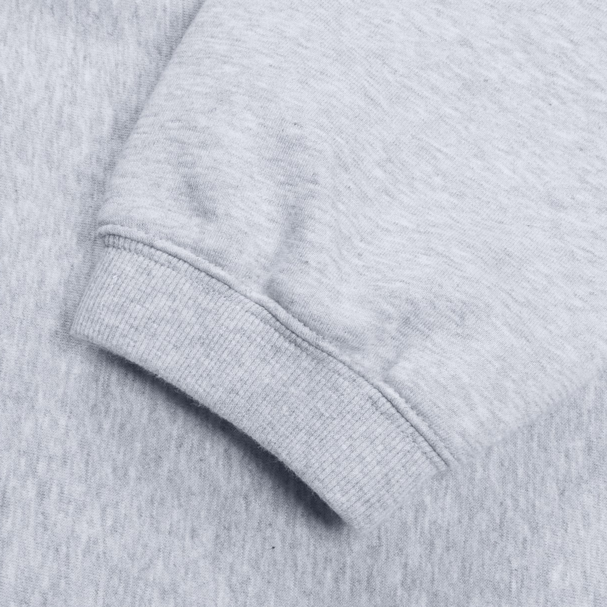 Close-up view of the cuff on a gray Women&#39;s Leisure Sweatpant by Canterbury, highlighting the ribbed texture of its cotton blend fleece.