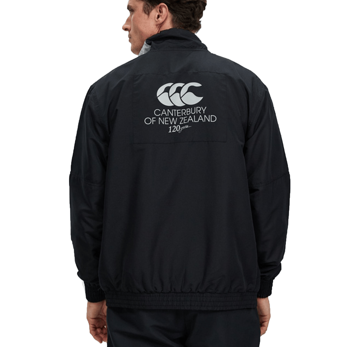 Man wearing a black Canterbury Legends Woven Track Jacket with the Canterbury logo on the back, viewed from behind.