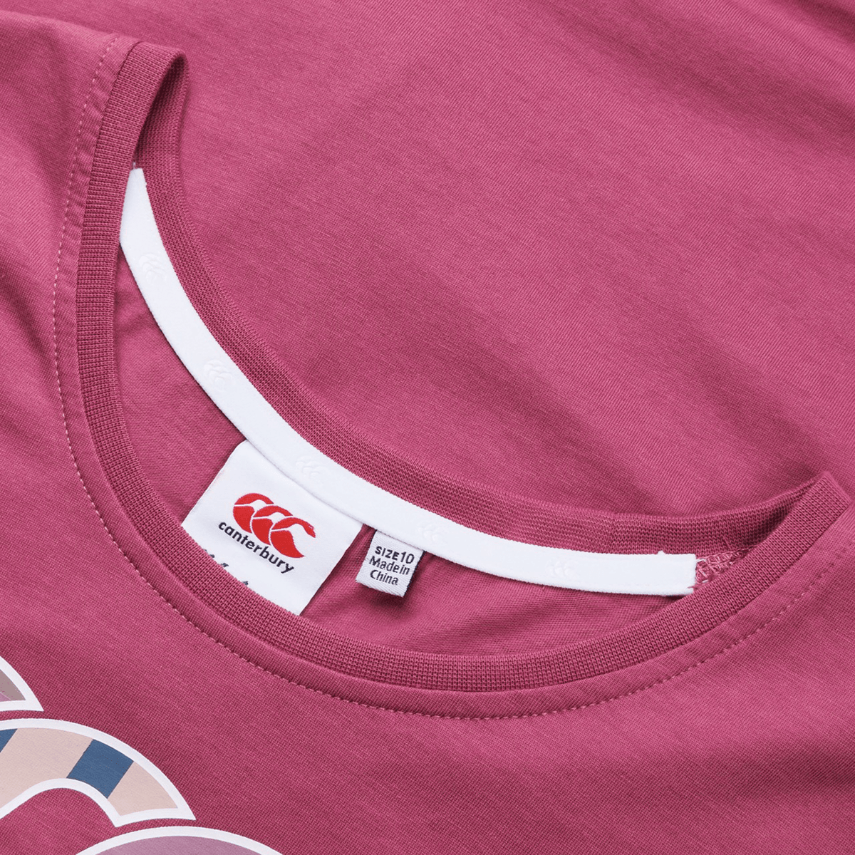 The Women&#39;s Canterbury Uglies T-Shirt in maroon has a stylish white neck trim and showcases the iconic brand label along with size details, blending comfort and style for those who appreciate sophistication.