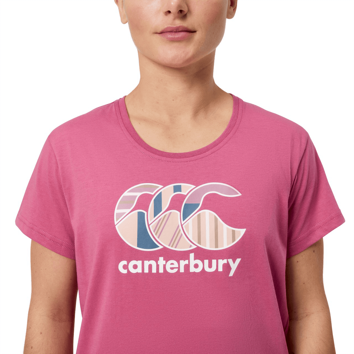 A person is wearing a women&#39;s Canterbury Uglies T-shirt, featuring a stylized wave design and &quot;Canterbury Uglies&quot; elegantly printed on the front.