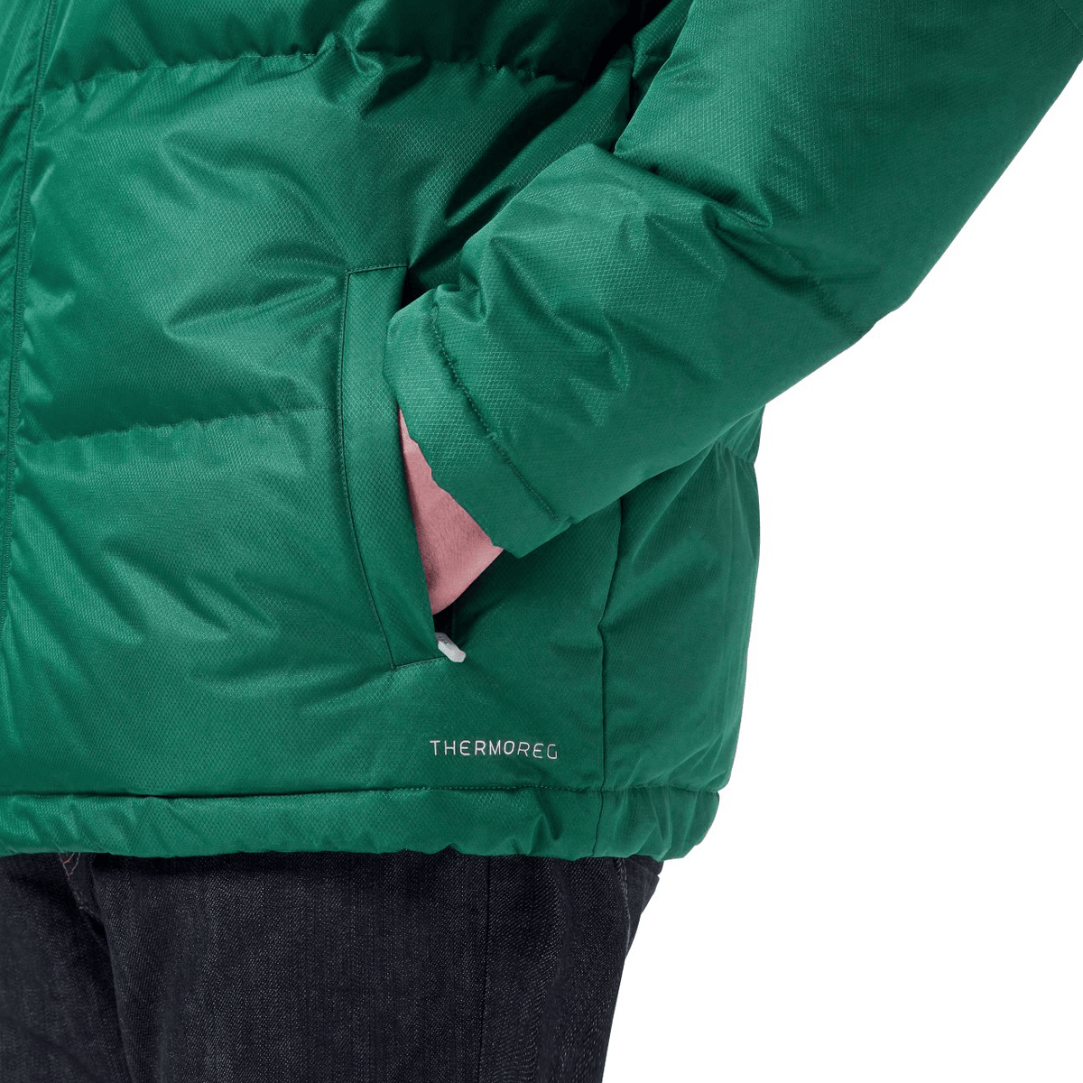 Close-up of someone wearing the Ireland 24 Puffer Jacket by Canterbury with &quot;THERMOREG&quot; text, their left hand in the pocket. The person, also in dark jeans, showcases this Just In piece perfectly for those chilly Canterbury days.