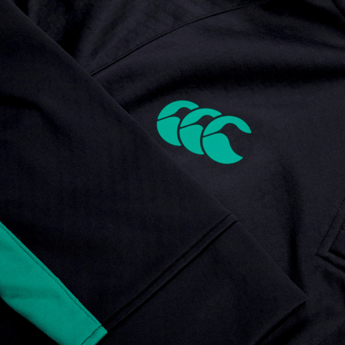 Close-up of the Ireland 1/4 Zip Training Top 25/26 by Canterbury, featuring a green logo, sleeve stripe, and Thermoreg technology for comfort.