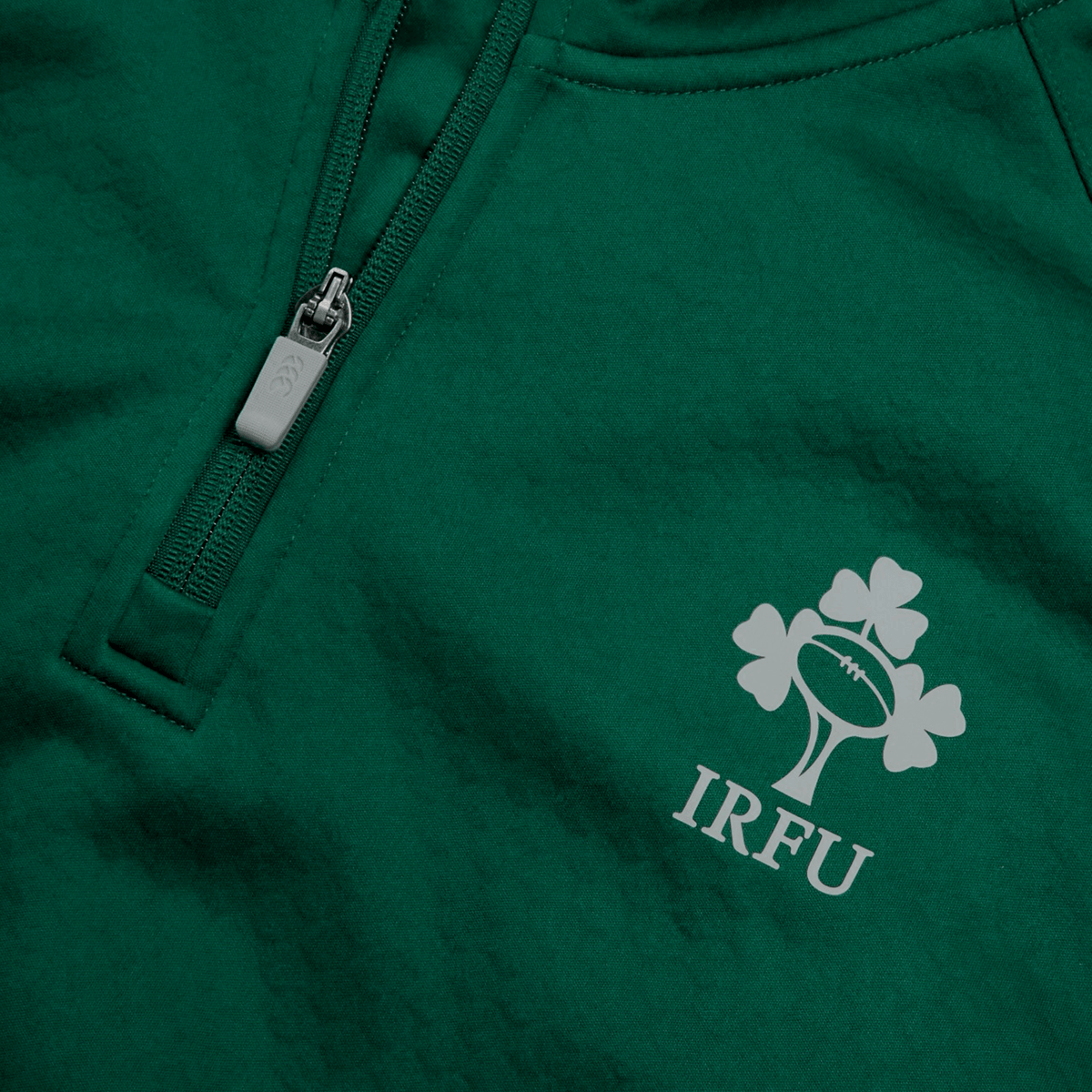 The Canterbury Ireland 1/4 Zip Training Top 25/26 is a green jacket with a zipper, inspired by the official Ireland training top.