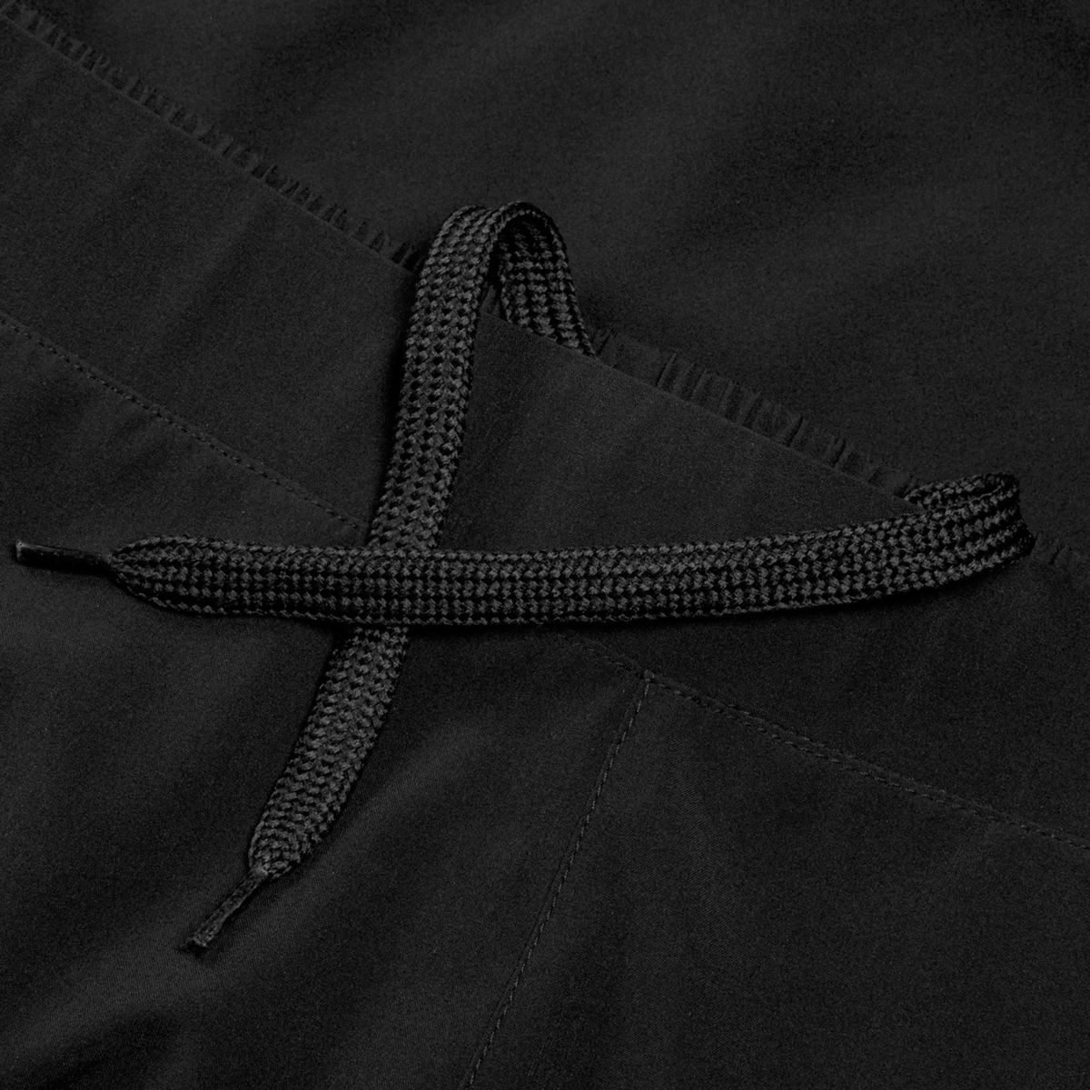 Close-up of a black drawstring tied in a loose knot on Women&#39;s Ireland 25/26 Woven Gym Short by Canterbury, made from soft black fabric.
