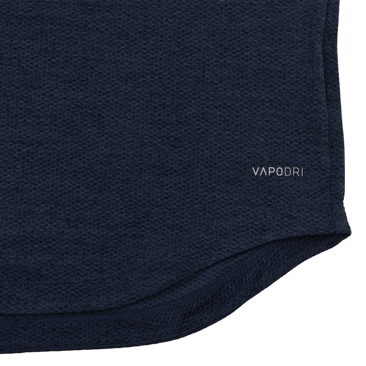 Close-up of the Ireland 26/27 Summer Tour Elite First Layer by Canterbury in navy blue textured fabric featuring Vapodri technology, with "VAPODRI" printed near the hem—a must-have for elite performance.