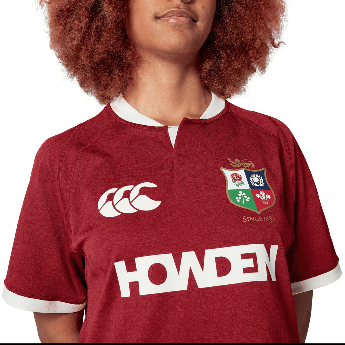 The person is wearing the British &amp; Irish Lions 2025 Players Jersey by Canterbury, featuring logos including the renowned British &amp; Irish Lions crest. Made from moisture-wicking fabric, this replica jersey offers comfort and style for passionate supporters.