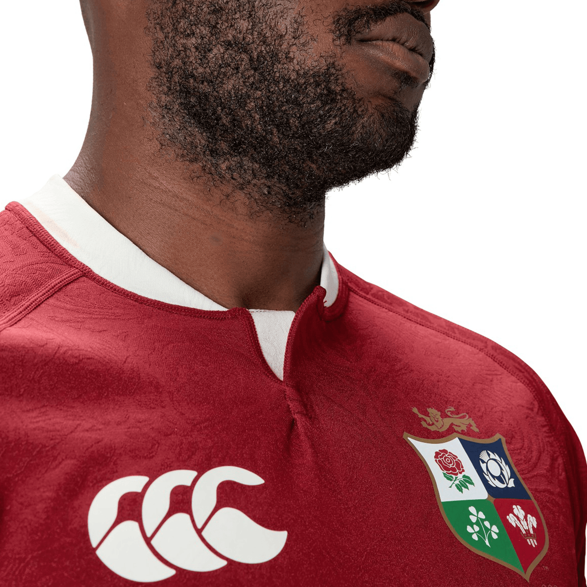 Someone wearing the British &amp; Irish Lions 2025 Players Jersey by Canterbury, characterized by its white collar and multi-emblem logo, enjoys the advantage of moisture-wicking fabric for exceptional comfort.