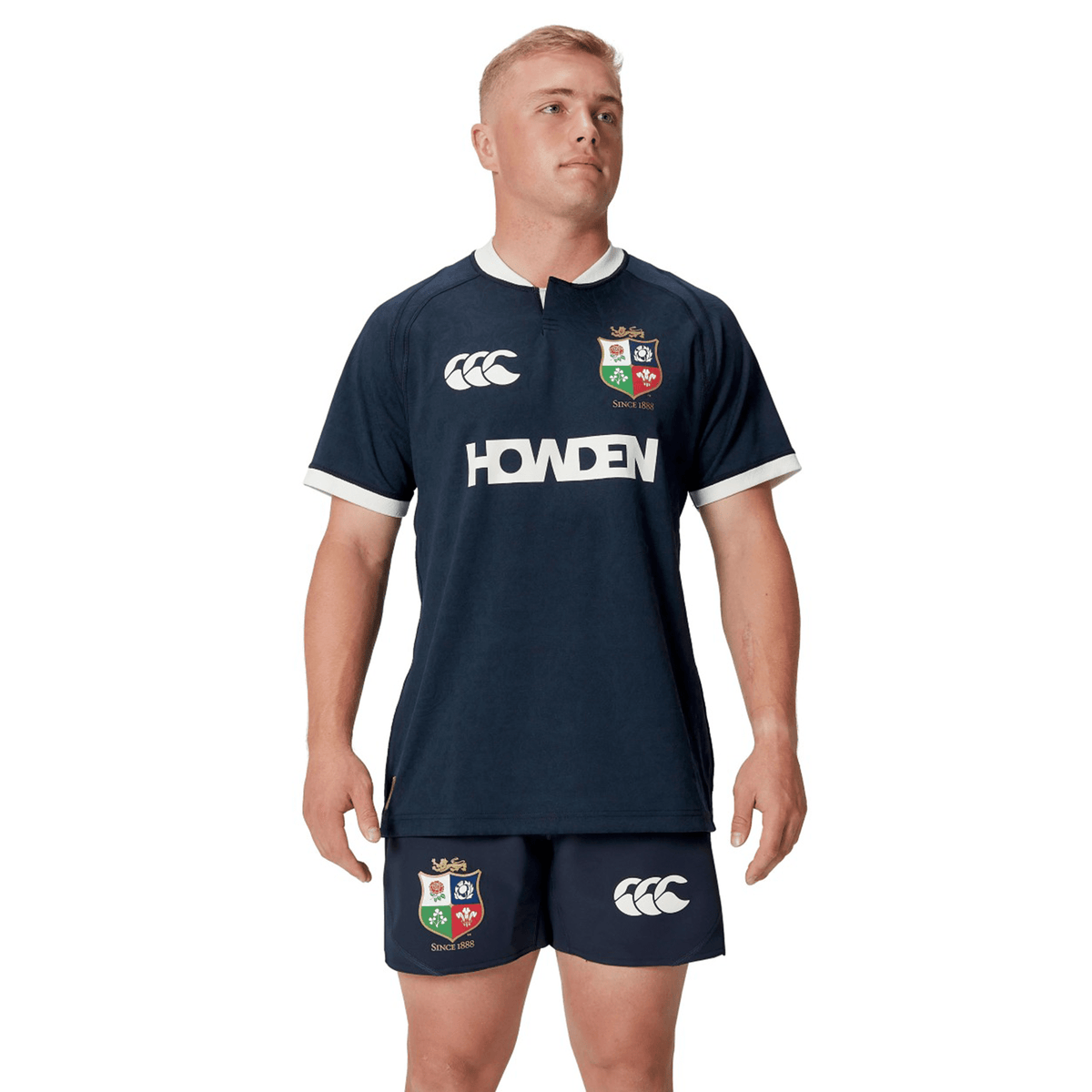 A person wearing a navy athletic outfit, featuring the British &amp; Irish Lions logo on the replica 2025 training jersey and shorts by Canterbury.