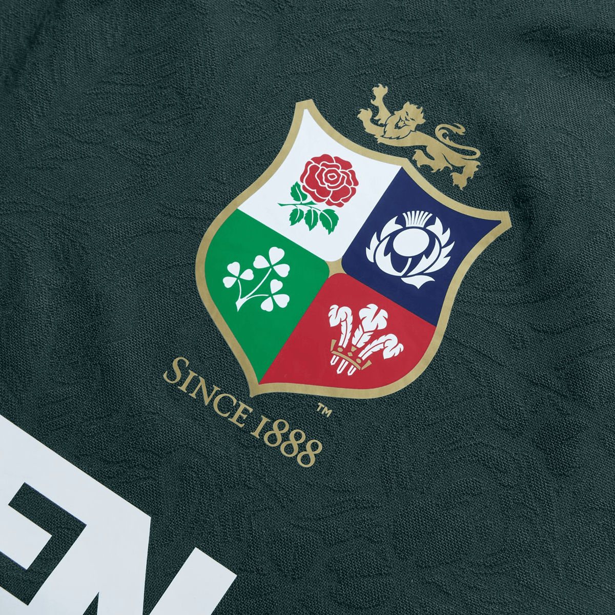 Close-up of the British &amp; Irish Lions 2025 Training Jersey by Canterbury, showcasing a crest with four symbols in its quadrants. The design is made from recycled polyester and includes the text "Since 1888" below.