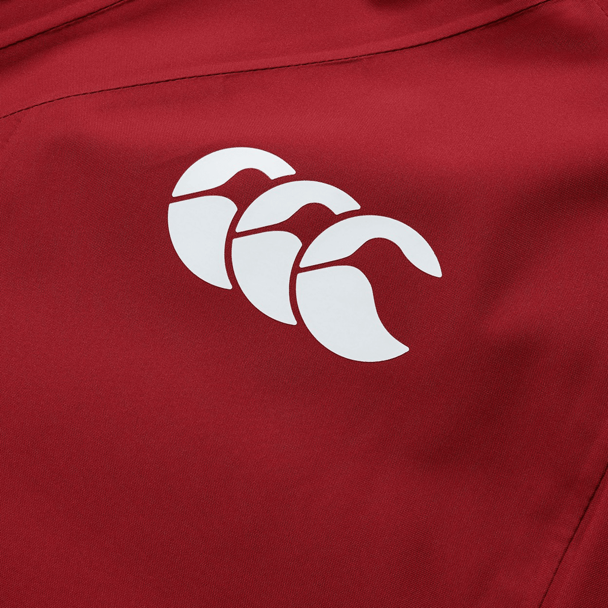 British &amp; Irish Lions 2025 waterproof jacket by Canterbury, made from red polyester fabric and adorned with a white Canterbury logo featuring three stylized overlapping shapes that evoke the iconic British &amp; Irish Lions design.