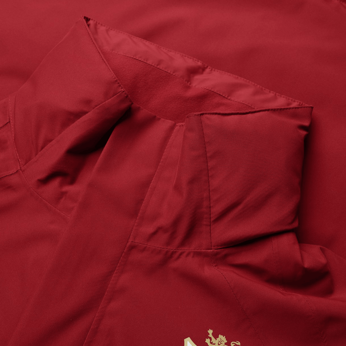 Close-up of the British &amp; Irish Lions 2025 Waterproof Jacket by Canterbury in red, showcasing its adjustable hood and a partially visible gold emblem on the lower right.