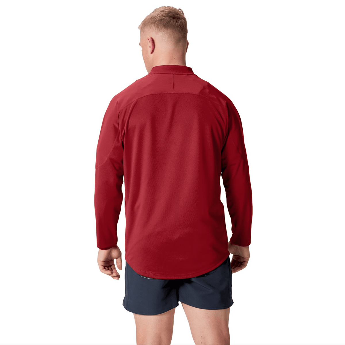 A person wearing the British &amp; Irish Lions 25 Drill Top by Canterbury paired with dark shorts stands facing away against a white background, embodying the classic style of the British &amp; Irish Lions.