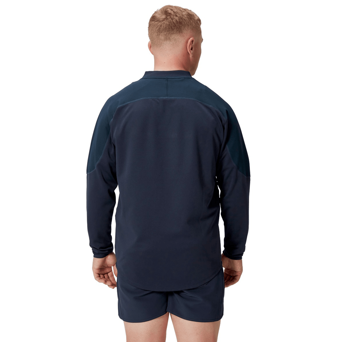 A person is shown from the back, wearing the British &amp; Irish Lions 25 Drill Top by Canterbury in a navy, performance fit athletic style, standing against a plain white background.