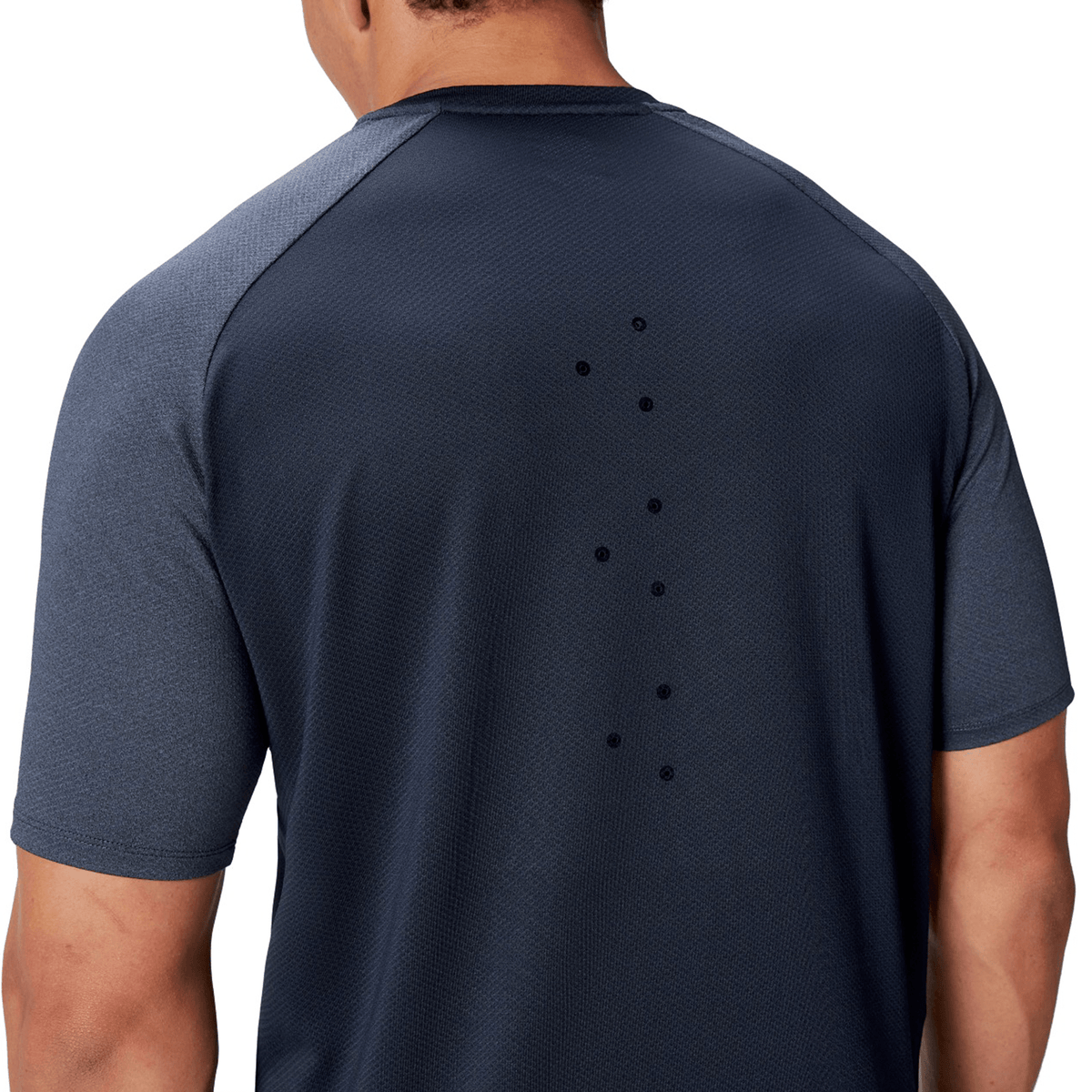 A person wearing a dark British &amp; Irish Lions 25 Everest Tee by Canterbury, featuring small ventilation holes on the back, looks ready for an intense workout.