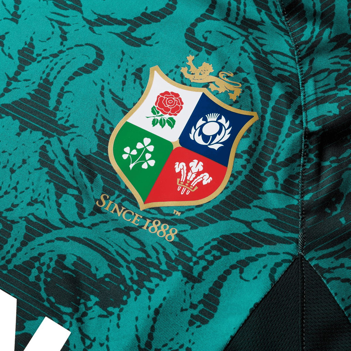 Close-up of the British &amp; Irish Lions 25 Superlight Training Tee by Canterbury in teal, featuring the renowned British &amp; Irish Lions emblem adorned with a rose, thistle, shamrock, and leek, along with the text &quot;Since 1888.
