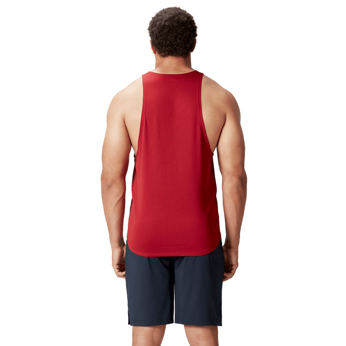 A man with short curly hair stands with his back to the camera, wearing a British &amp; Irish Lions 25 Poly Singlet by Canterbury in red and dark shorts.