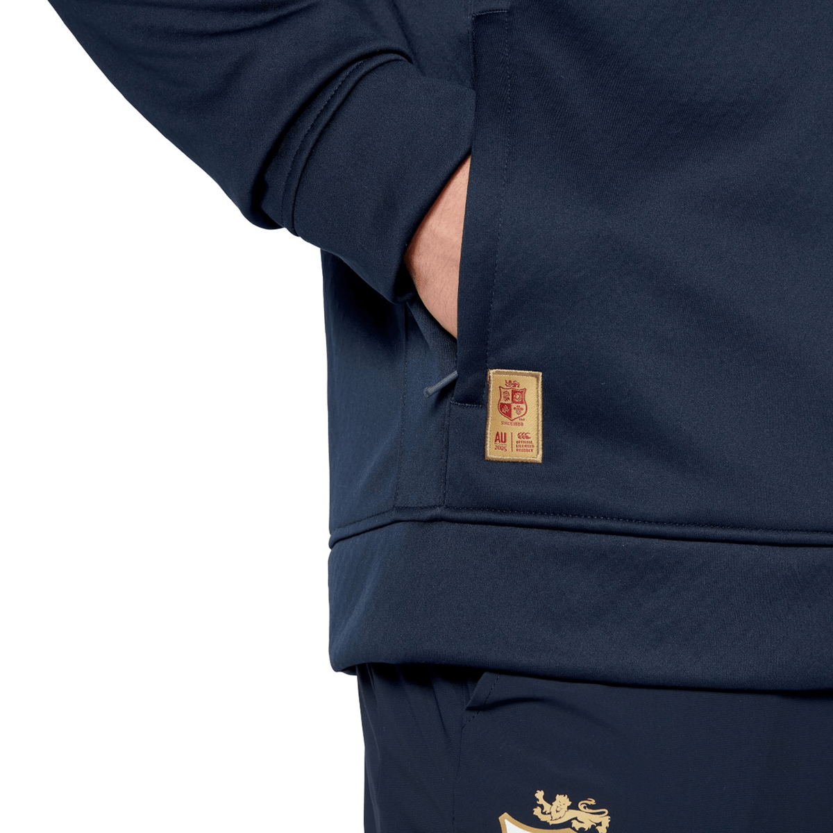 Someone wearing the British &amp; Irish Lions 2025 1/4 Zip Fleece by Canterbury, hands casually tucked in their pockets, could easily be mistaken for a devoted fan of the Canterbury brand.