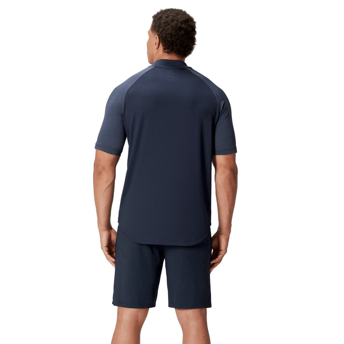 A man in a British &amp; Irish Lions 25 Poly Polo by Canterbury and shorts stands with his back to the camera against a plain white background. The quick-drying fabric guarantees comfort, making it ideal for any activity.