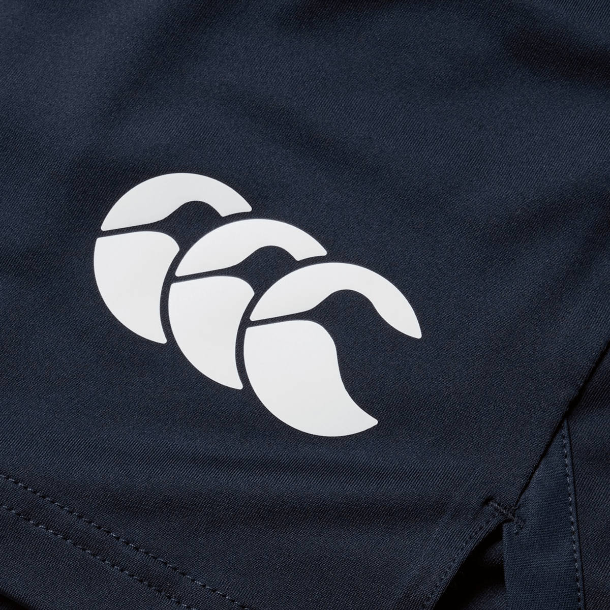 Close-up of a British &amp; Irish Lions 2025 Training Short by Canterbury in dark blue fabric, featuring the distinctive white triple arc logo.