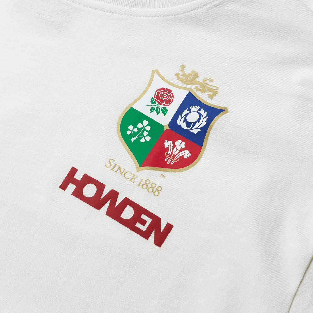 This British &amp; Irish Lions 2025 Cotton Jersey Tee by Canterbury, made from organic cotton, features a vibrant crest with a lion on top. Below, the text reads "Since 1888" and "Howden" in red—perfect for any rugby supporter.