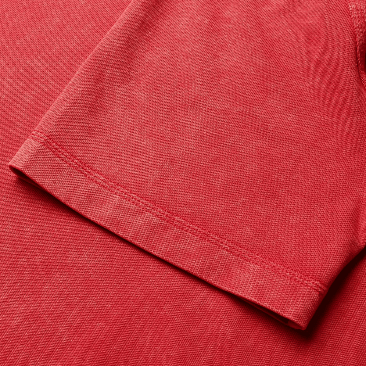 Close-up of a red short-sleeve British &amp; Irish Lions 25 Heritage Tee by Canterbury, capturing the intricate sleeve and texture detail with impressive precision.