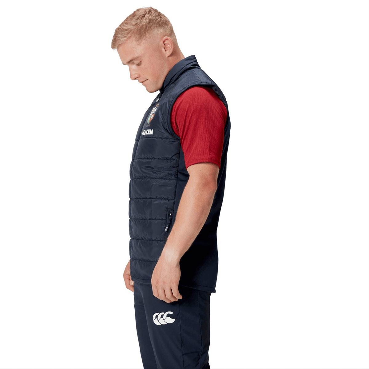A man wearing the British &amp; Irish Lions 2025 Microlight Gilet by Canterbury, crafted from thermoreg fabric, stands in profile against a white background.