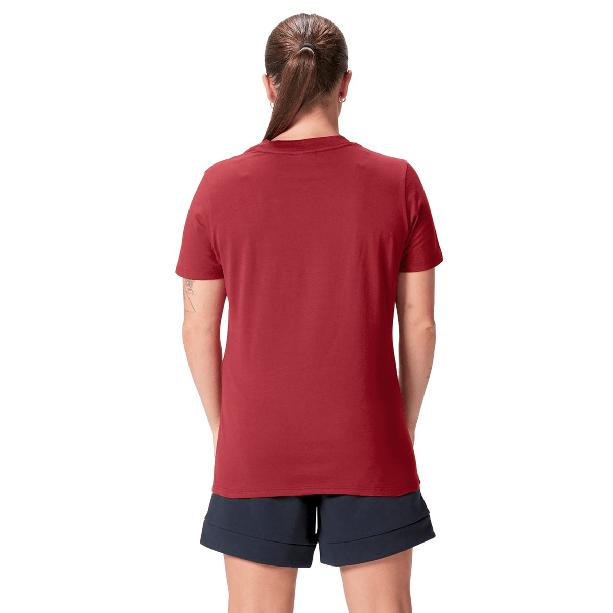 A person facing away, wearing the Canterbury Women's British &amp; Irish Lions 25 Cotton Jersey Tee in red and navy shorts, with hair tied back.