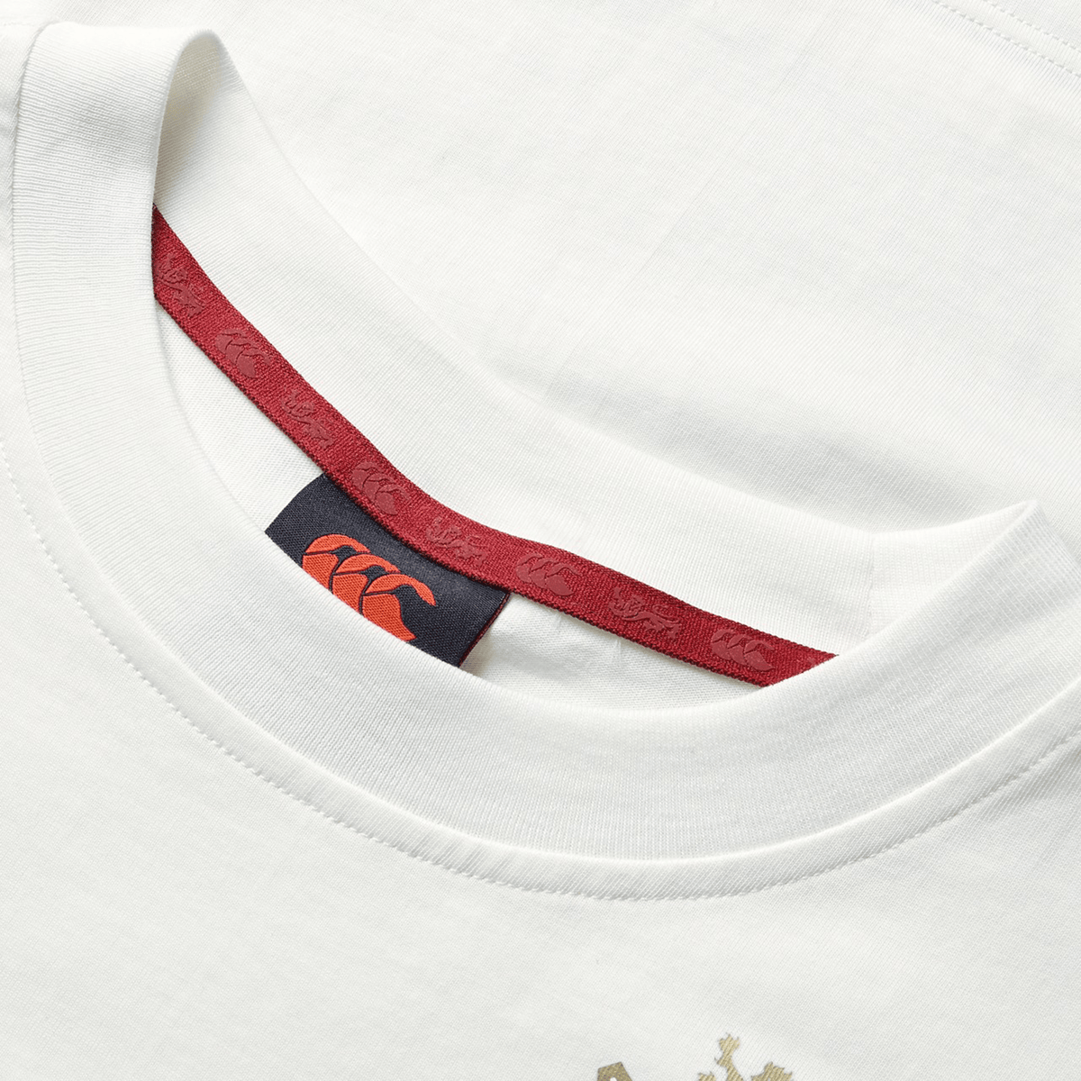 A close-up of the British &amp; Irish Lions 2025 Women's Cotton Jersey Tee by Canterbury, a white T-shirt made from organic cotton with a red interior neckline and a visible logo tag, ideal for the discerning rugby supporter.