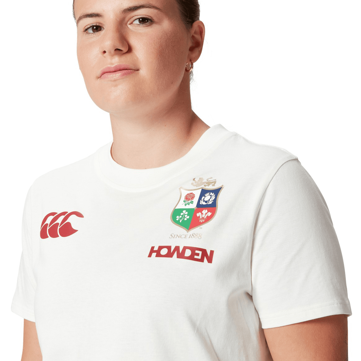 A dedicated rugby fan proudly wears the Women's British &amp; Irish Lions 25 Cotton Jersey Tee by Canterbury, featuring the Canterbury brand and Howden logos to display their loyalty to the British &amp; Irish Lions.