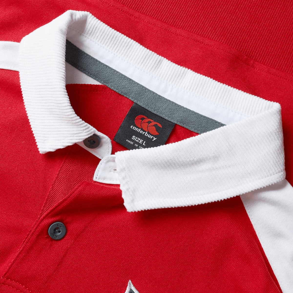 The British &amp; Irish Lions 2025 Heritage Jersey by Canterbury is a red collared shirt with white trim, featuring the iconic Canterbury logo tag inside and a size label indicating 3XL. This timeless piece captures the spirit of a Heritage Jersey, making it ideal for fans of the British &amp; Irish Lions.