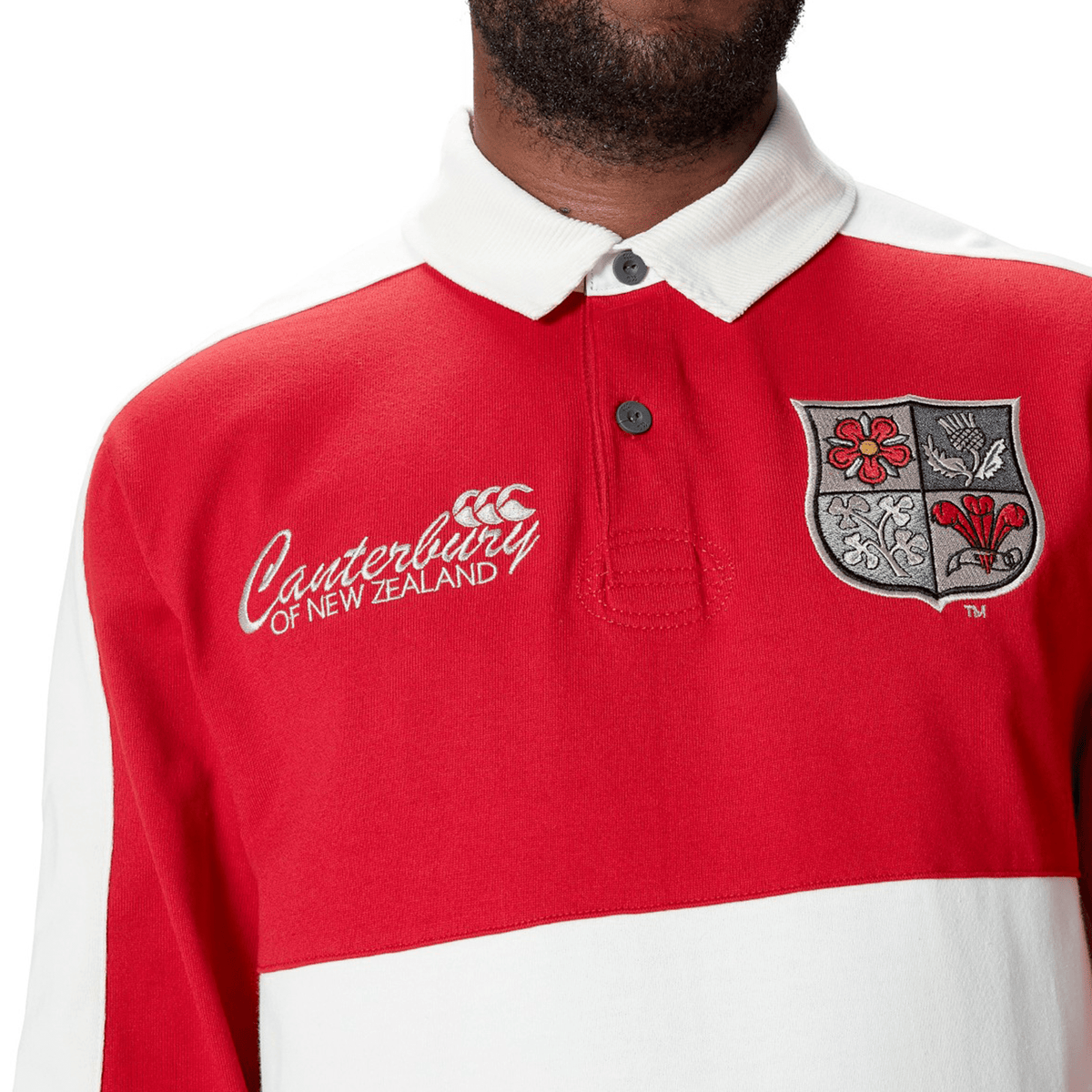 A person wearing the British &amp; Irish Lions 2025 Heritage Jersey by Canterbury, crafted from a premium cotton blend, showcases an embroidered crest on the chest.