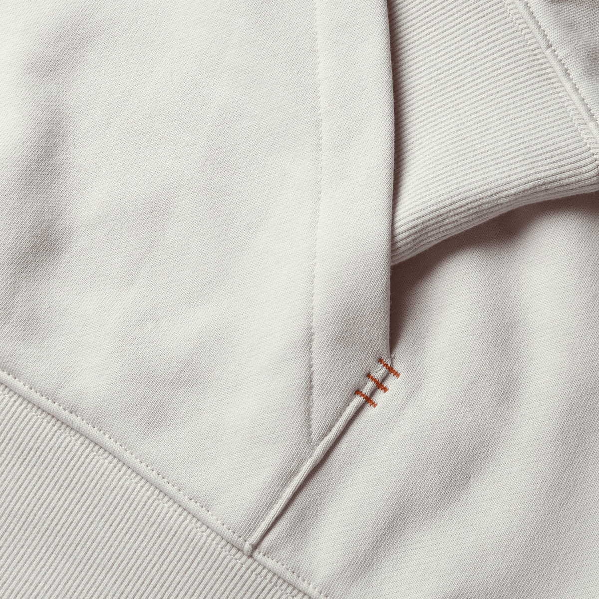 Close-up of a beige British &amp; Irish Lions 2025 Outback Fleece Hoodie by Canterbury, highlighting its detailed stitching and cotton texture, evoking the rugged charm typical of Canterbury's apparel.